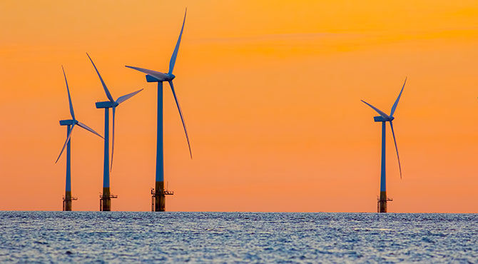 a photo of UK wind farms illustrates an article about new inward investment into the UK announced by Prime Minister Theresa May