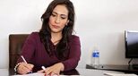 Women signing paperwork