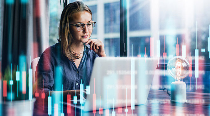 Woman at computer with financial algorithms overlaid over photo