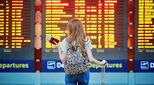 Woman travelling holding passport, supporting family employment in global mobility policy