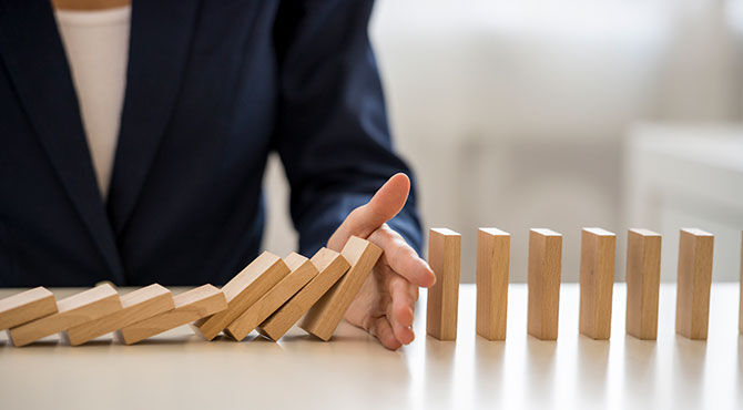 Woman blocking dominoes