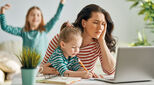 Woman on laptop with two children