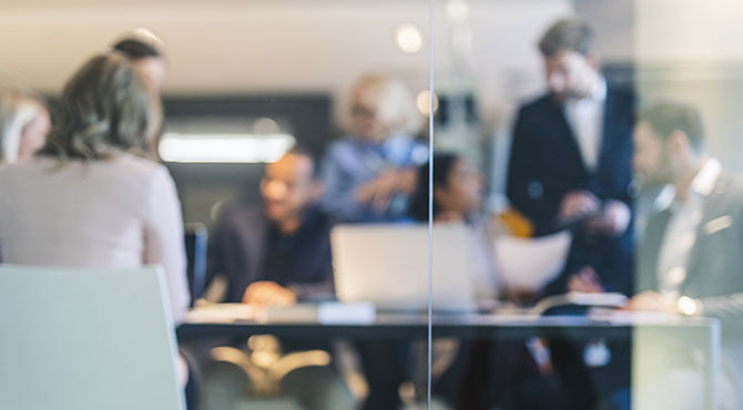 Workers in office as seen through glass