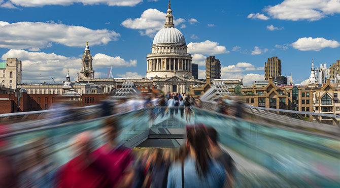 Workers on Millennium Bridge in London with St Paul's in the background