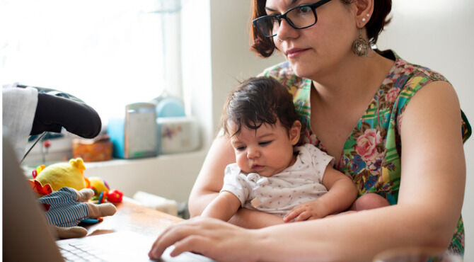 Working mom with baby in a lap