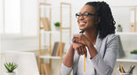 usiness Career Concept. Afro Businesswoman Smiling Sitting In Modern Office. Copy Space