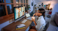 Smiling businesswoman having video call while working from home office