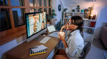 Smiling businesswoman having video call while working from home office